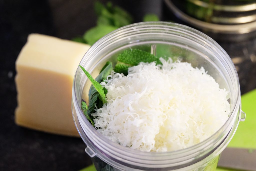 Close up of a nutribullet with grated cheese inside