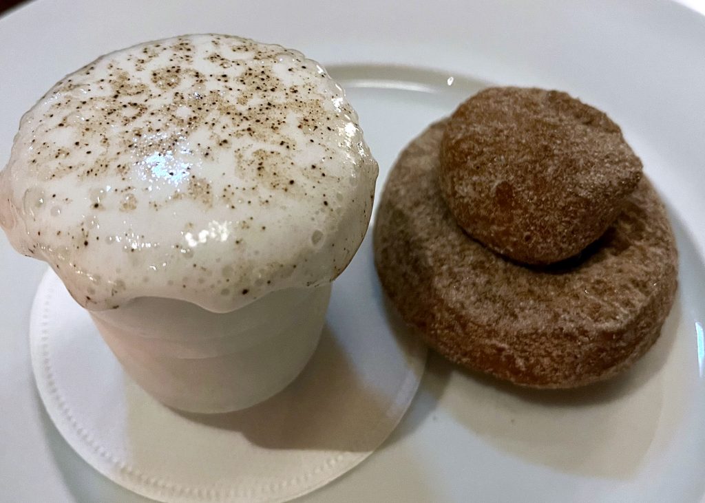 A coffee donut with coffee foam is a dessert at Dovetale