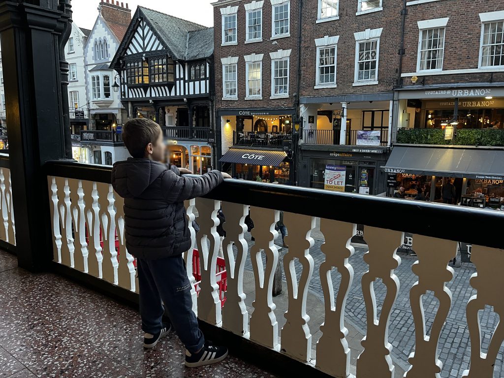 A child overlooking Chester's Bridge Street from the Rows