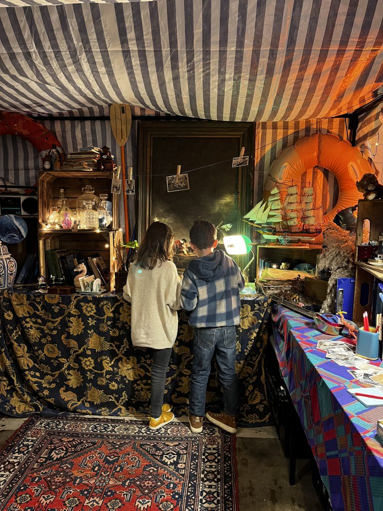 Two kids looking around Fireside Tales set