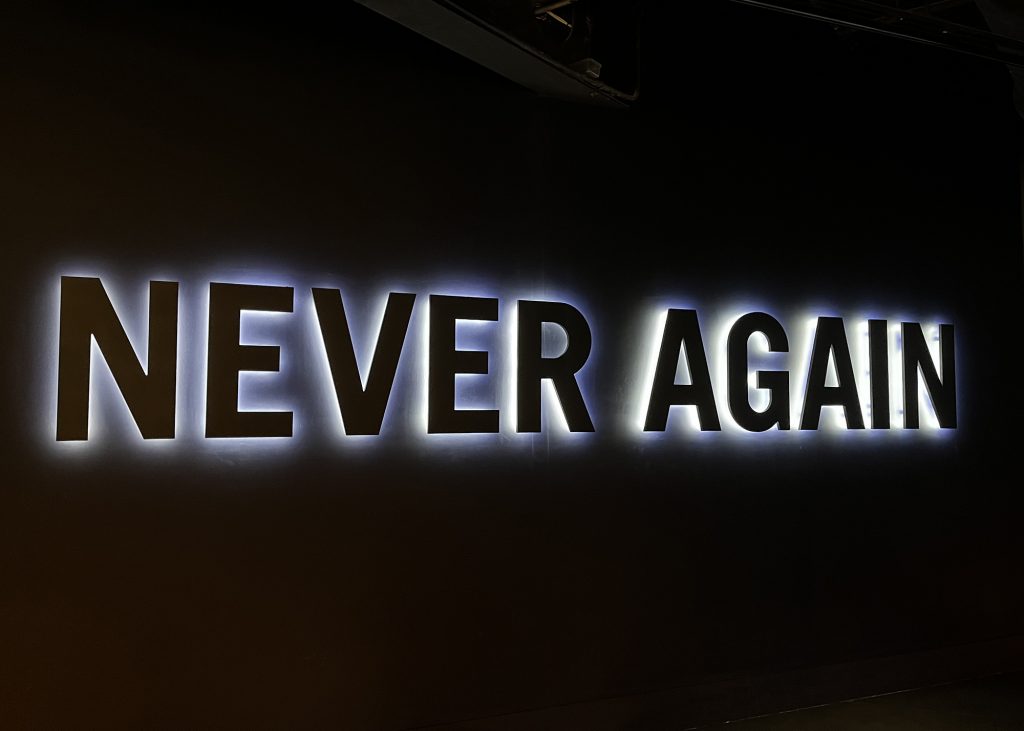 Never again neon sign at Belfast Titanic Museum