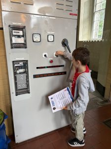 A child operating a machine at the London Museum of Water and Steam